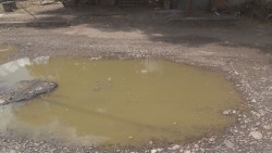 Calle Brasiles en malas condiciones, llena de baches